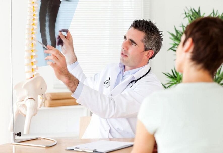 The doctor examines the radiograph to determine the osteochondrosis of the chest